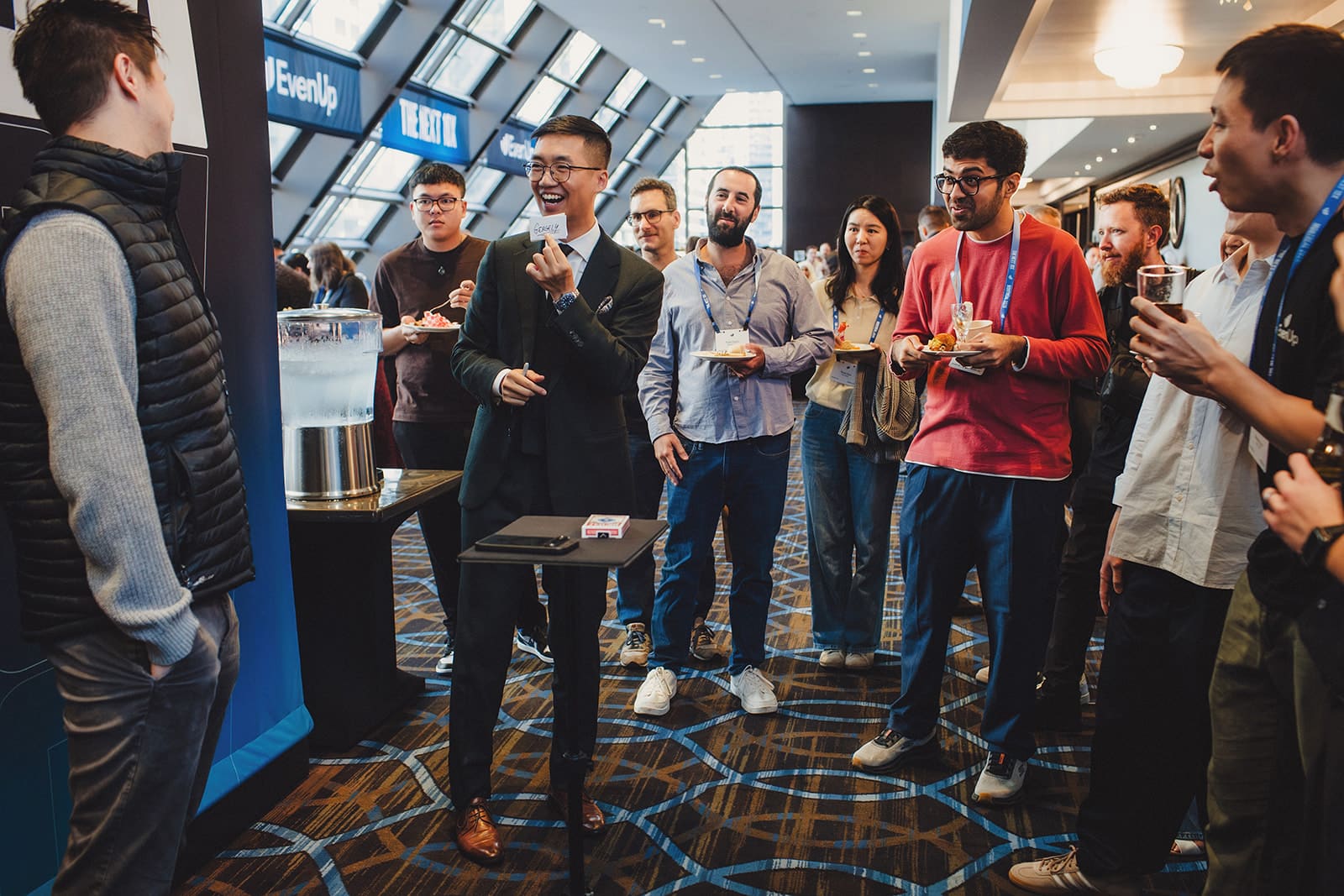 Bao performing close-up magic for a group of EvenUp guests during the cocktail hour of their Montreal company offsite