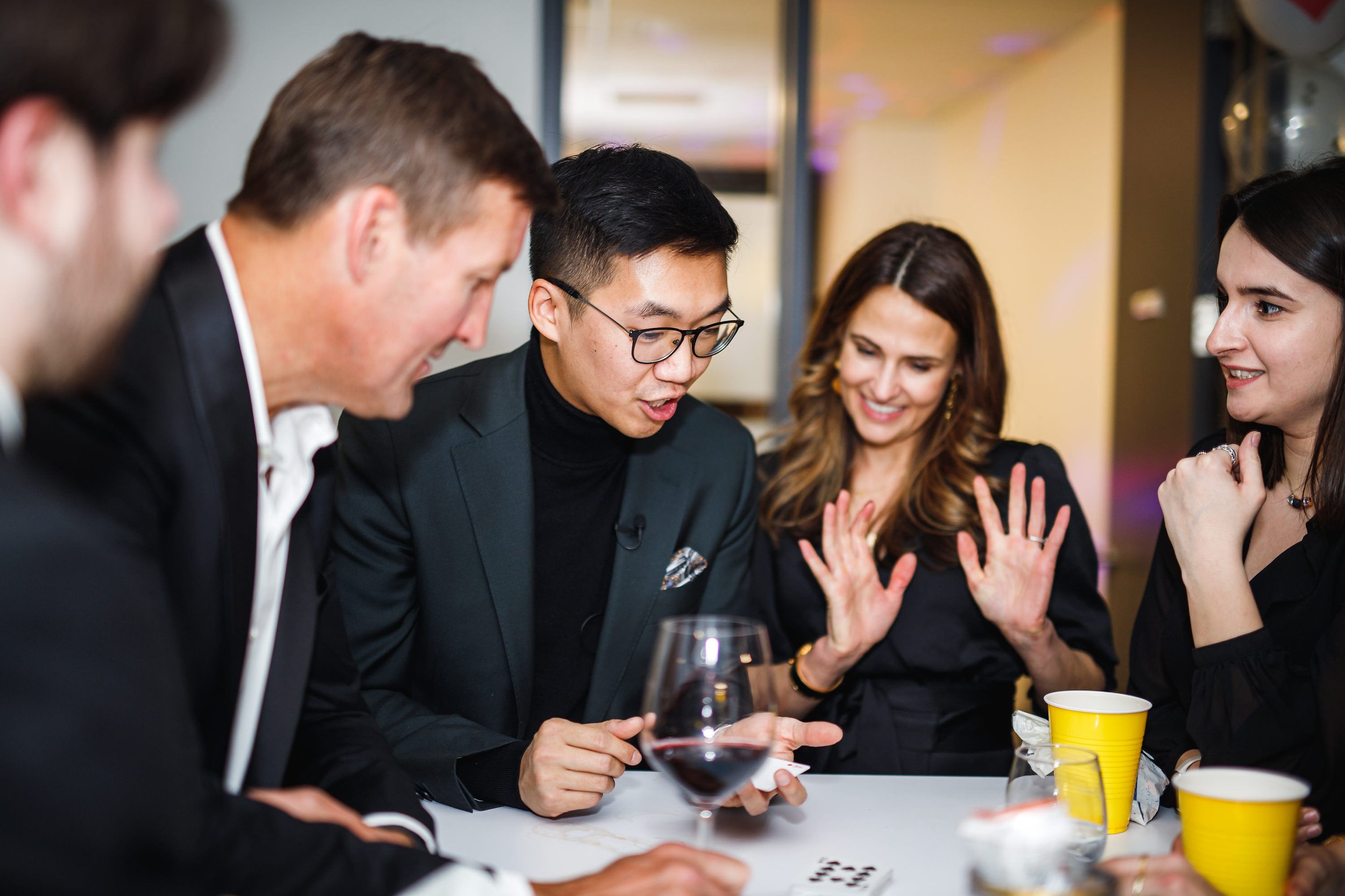 Guests reacting to close-up magic at a brand event